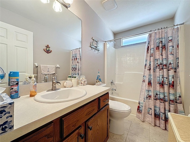 bathroom featuring vanity, tile patterned flooring, shower / tub combo, a textured ceiling, and toilet