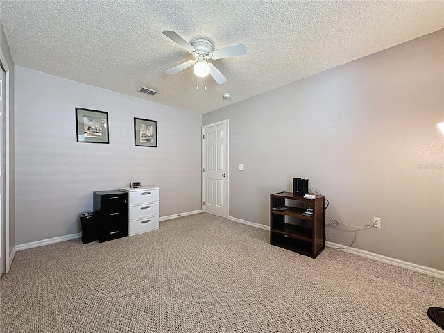 interior space featuring carpet flooring, baseboards, visible vents, and a textured ceiling