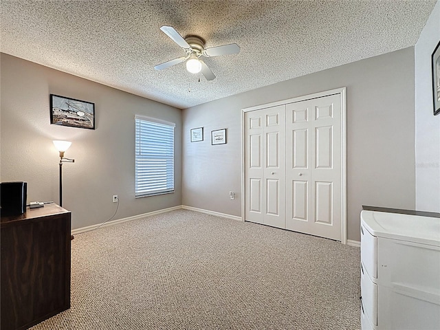 carpeted office with baseboards, a textured ceiling, ceiling fan, and washer and clothes dryer