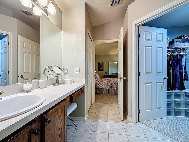 ensuite bathroom featuring tile patterned floors, visible vents, connected bathroom, and vanity