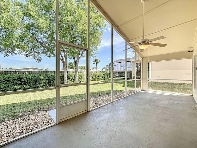 unfurnished sunroom with a ceiling fan