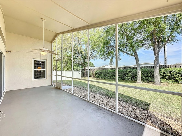 unfurnished sunroom with a wealth of natural light and a ceiling fan