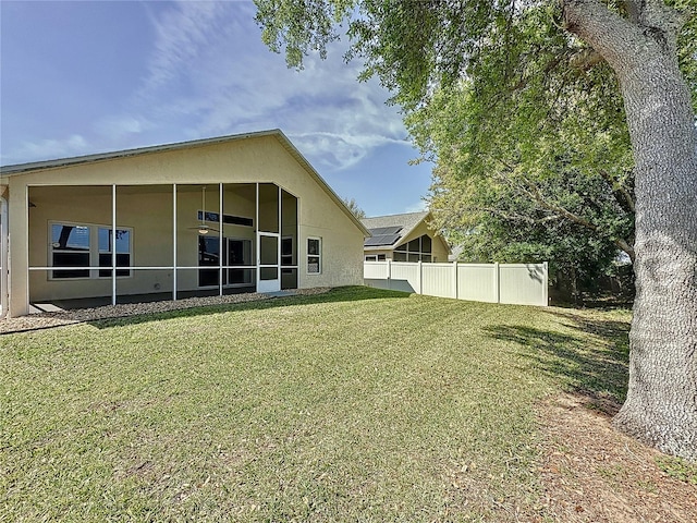 view of yard with a sunroom and fence