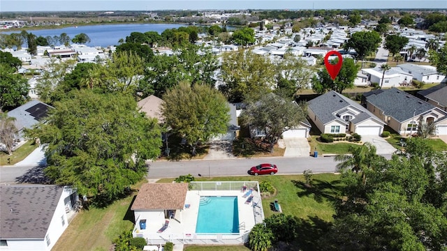 drone / aerial view featuring a residential view and a water view