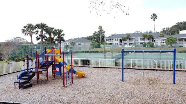 communal playground with a residential view and fence