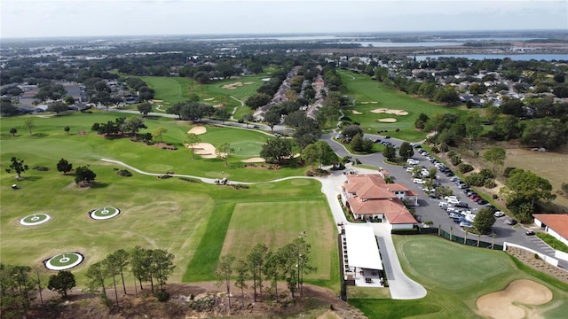 birds eye view of property with a water view and view of golf course