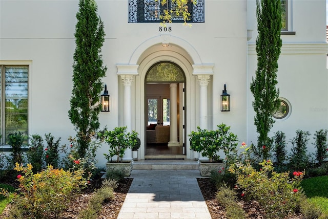 entrance to property featuring stucco siding