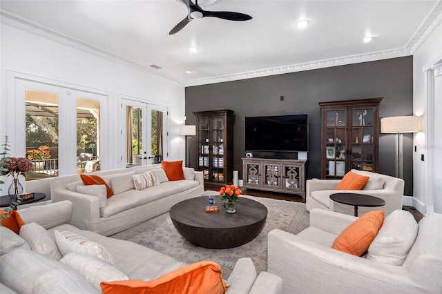 living area featuring french doors, visible vents, wood finished floors, and crown molding