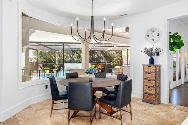 dining room with visible vents, baseboards, stone tile floors, and a sunroom