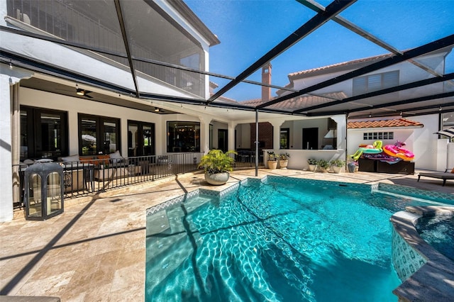 outdoor pool featuring a ceiling fan, a lanai, and a patio area