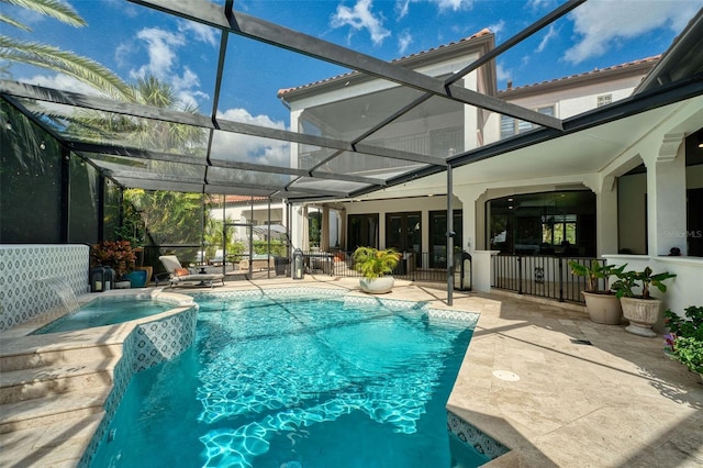 view of pool with a patio, a lanai, and a pool with connected hot tub