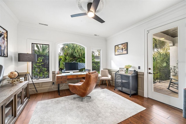 office space with visible vents, a wainscoted wall, crown molding, and hardwood / wood-style flooring