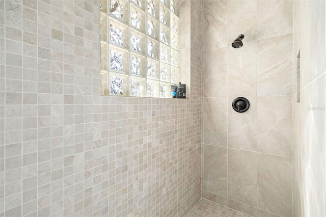 full bath featuring a tile shower