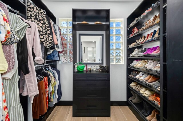 walk in closet featuring wood finished floors