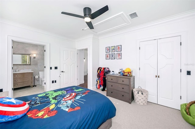 carpeted bedroom with ensuite bath, visible vents, a closet, and ornamental molding