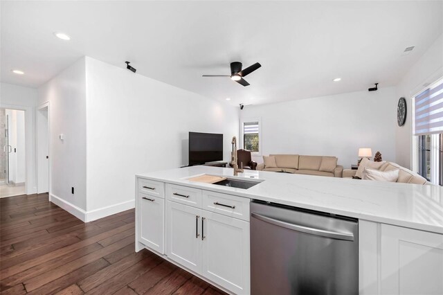 kitchen with a sink, open floor plan, dishwasher, white cabinets, and dark wood-style flooring