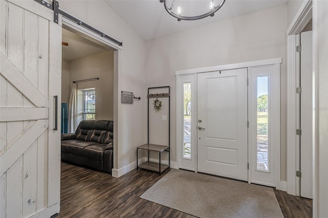 entrance foyer featuring a barn door, baseboards, and dark wood-style flooring