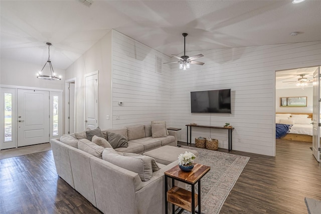 living room featuring dark wood-style flooring and ceiling fan with notable chandelier