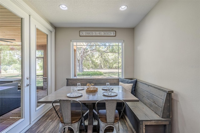 dining room with recessed lighting, breakfast area, a textured ceiling, and wood finished floors