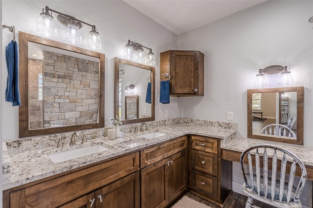 full bath with a sink and double vanity