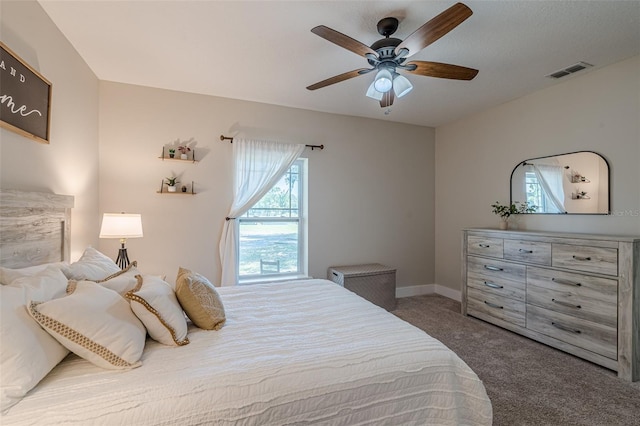 bedroom featuring visible vents, multiple windows, carpet, and ceiling fan