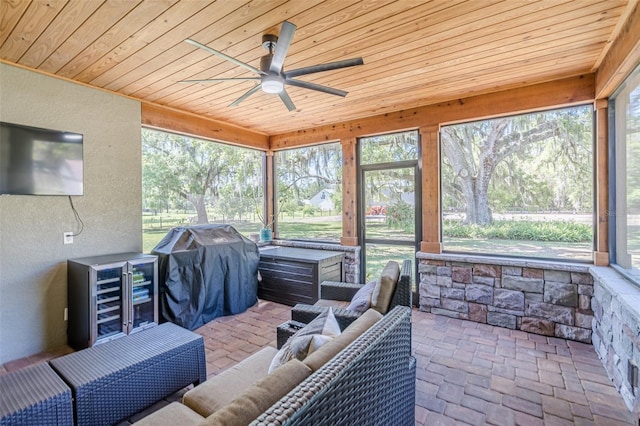 sunroom with wine cooler, wooden ceiling, and ceiling fan