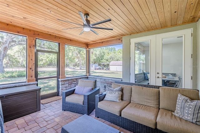 sunroom featuring wooden ceiling, a ceiling fan, and french doors