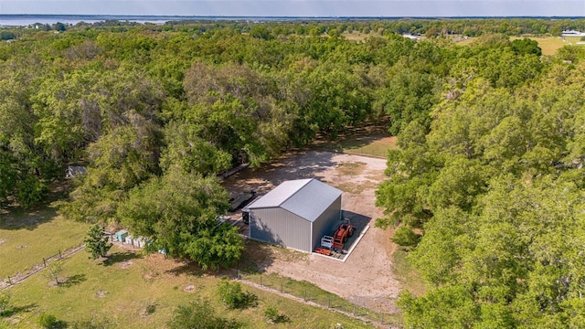 drone / aerial view with a wooded view