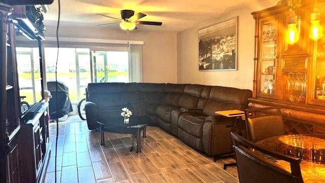 living room featuring a ceiling fan and wood tiled floor