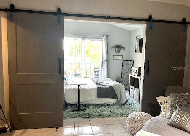 2560 Woodgate Blvd Unit 203, Orlando, FL 32822 - bedroom with a barn door and light tile patterned flooring