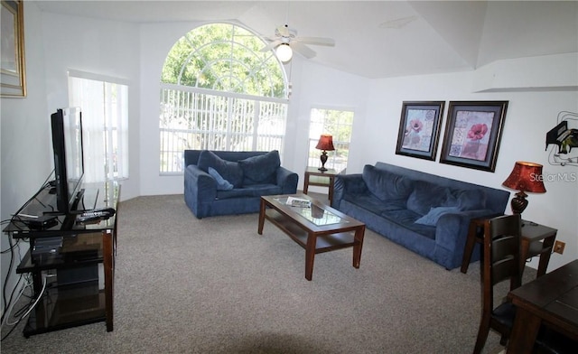 living area with lofted ceiling, a ceiling fan, and carpet flooring