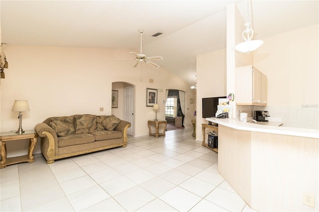 living room featuring light tile patterned flooring, a ceiling fan, visible vents, vaulted ceiling, and arched walkways
