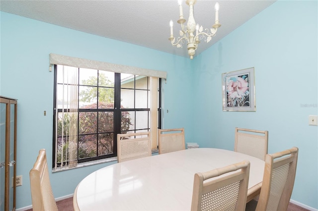 dining room featuring baseboards and a notable chandelier