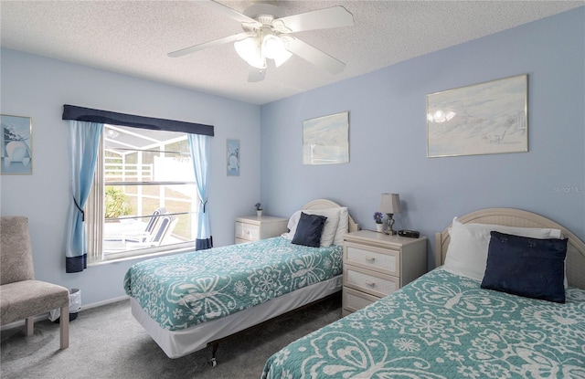 bedroom with baseboards, ceiling fan, a textured ceiling, and carpet