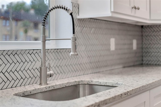 415 S 9th St, Leesburg, FL 34748 - room details featuring white cabinetry, a sink, and light stone countertops