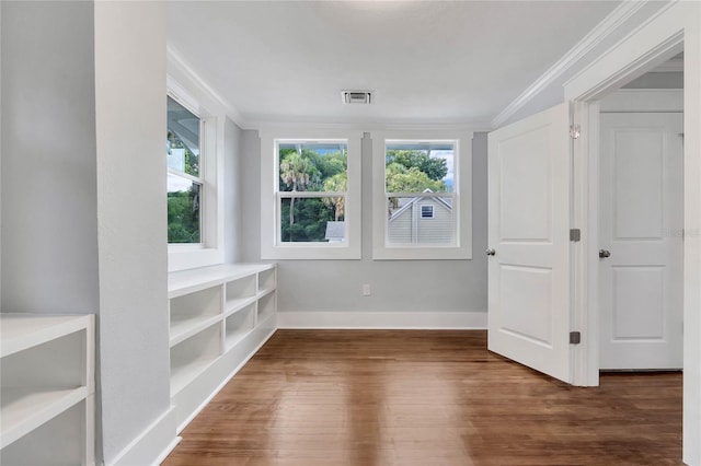 415 S 9th St, Leesburg, FL 34748 - spare room with a wealth of natural light, visible vents, crown molding, and wood finished floors