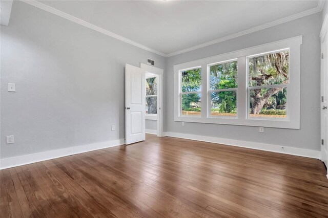 415 S 9th St, Leesburg, FL 34748 - unfurnished room with wood finished floors, crown molding, baseboards, and visible vents