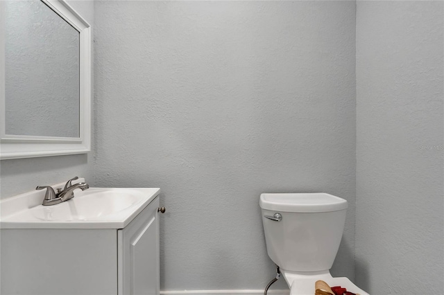 415 S 9th St, Leesburg, FL 34748 - half bathroom featuring a textured wall, toilet, and vanity