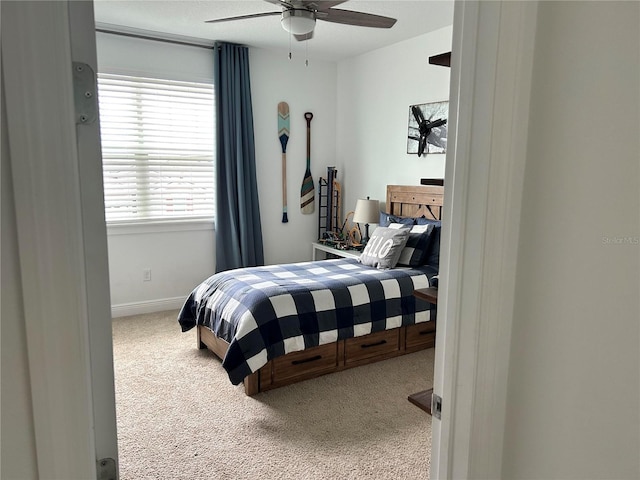 carpeted bedroom featuring ceiling fan and baseboards