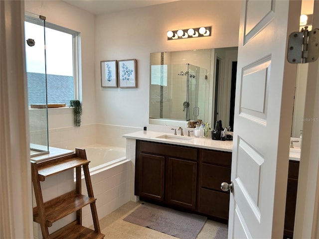 bathroom with a garden tub, a shower stall, and vanity