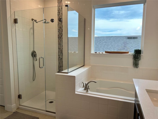 bathroom featuring a shower stall, vanity, and a bath