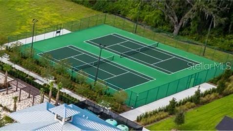 view of sport court with a yard and fence