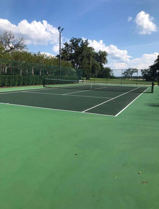 view of tennis court with fence