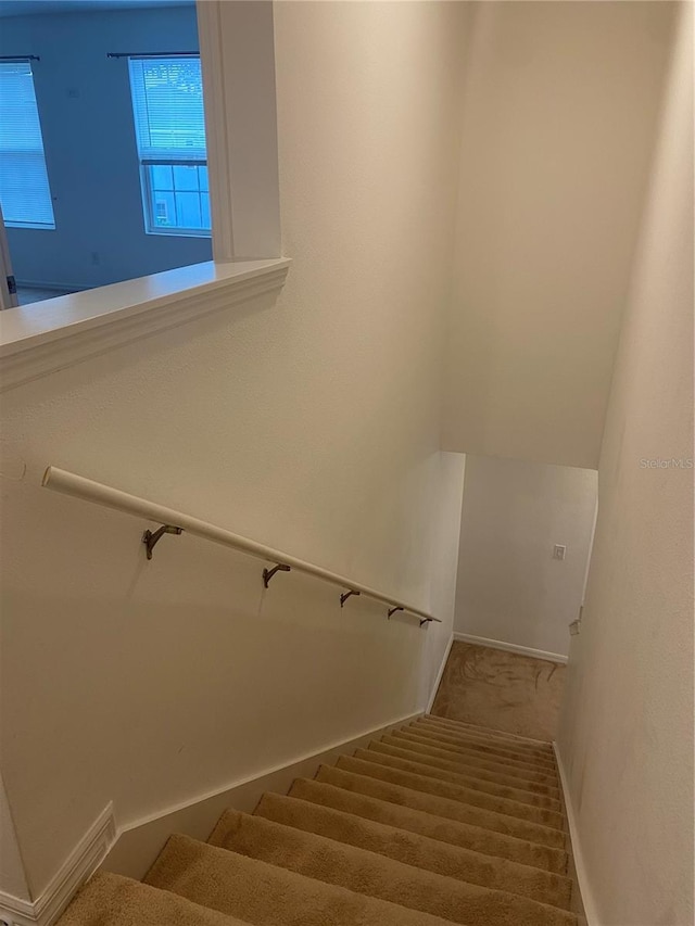 staircase featuring baseboards