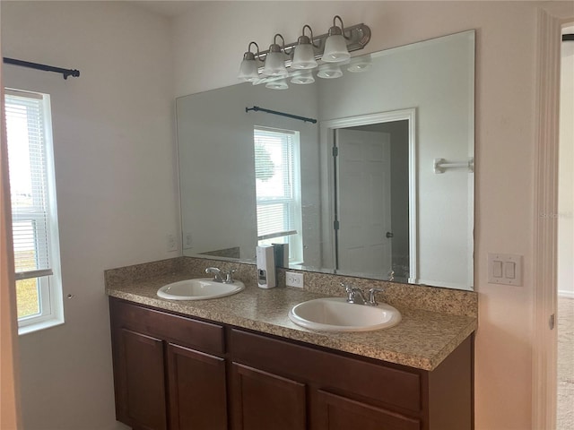 full bathroom featuring a sink and double vanity