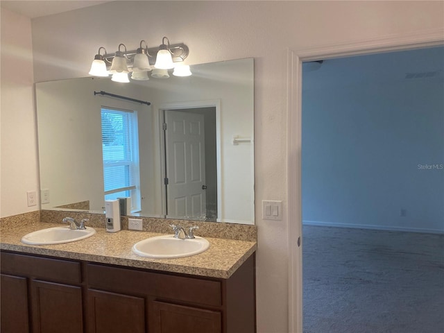 bathroom featuring a sink and double vanity