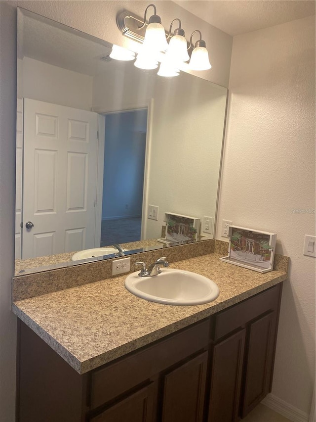 bathroom with vanity and a notable chandelier