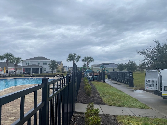 community pool featuring mail area and fence