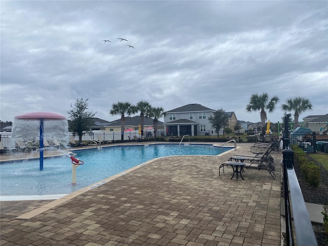 pool featuring a patio and fence