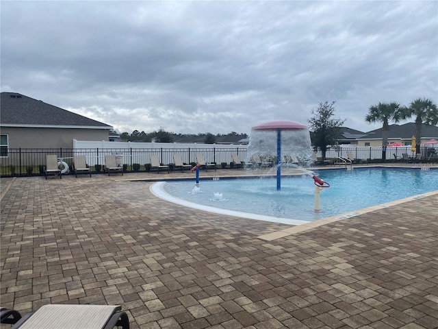 community pool featuring a patio area and fence